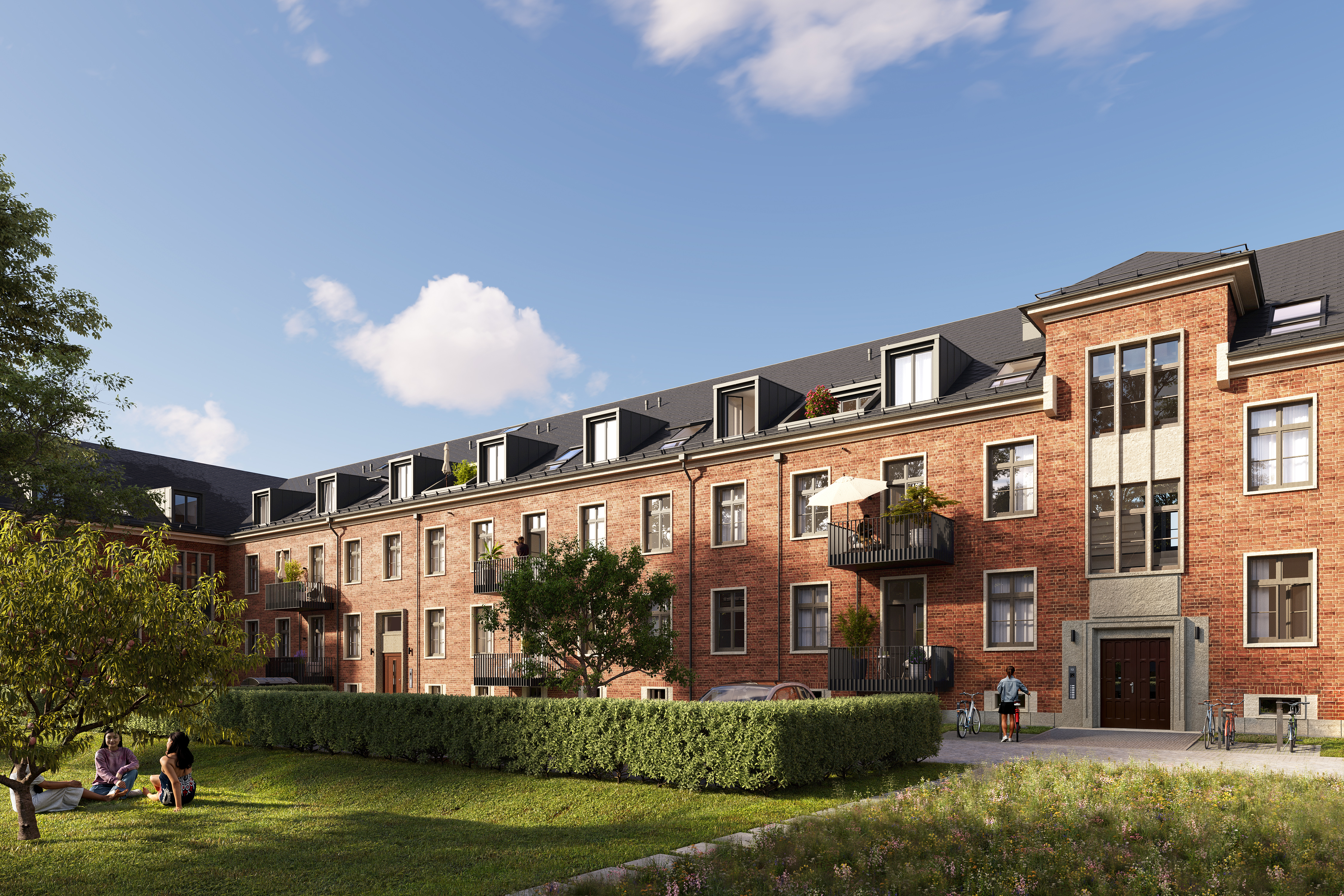 A brown house of the BUWOG Lillestad project with a large green area and people on the green area can be seen from the front.