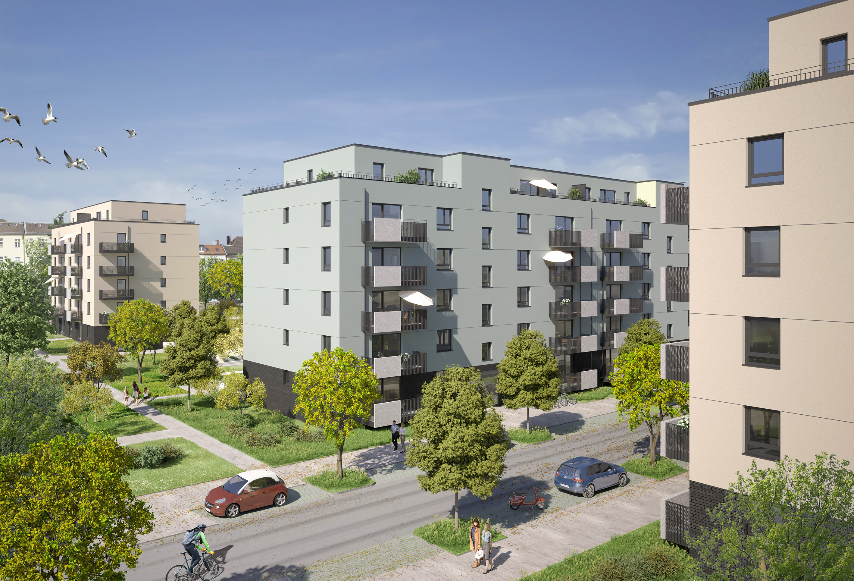 You can see several buildings in light brown and mint green, surrounded by streets, green spaces and vehicles.