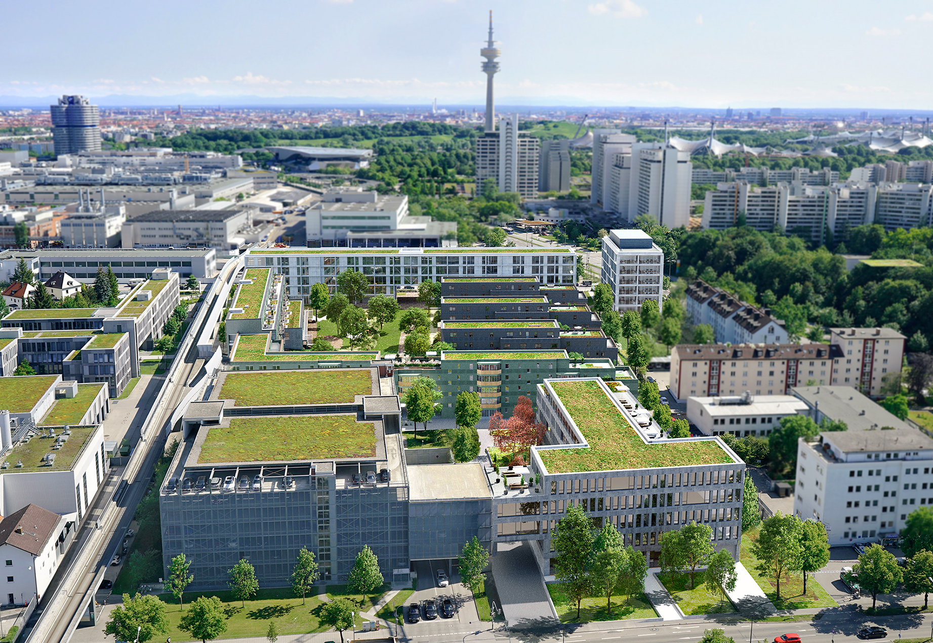 The Projekt Hofmark am Olympiapark, consisting of several buildings, can be seen from the air during the day. The green meadows on the roofs of the buildings stand out.