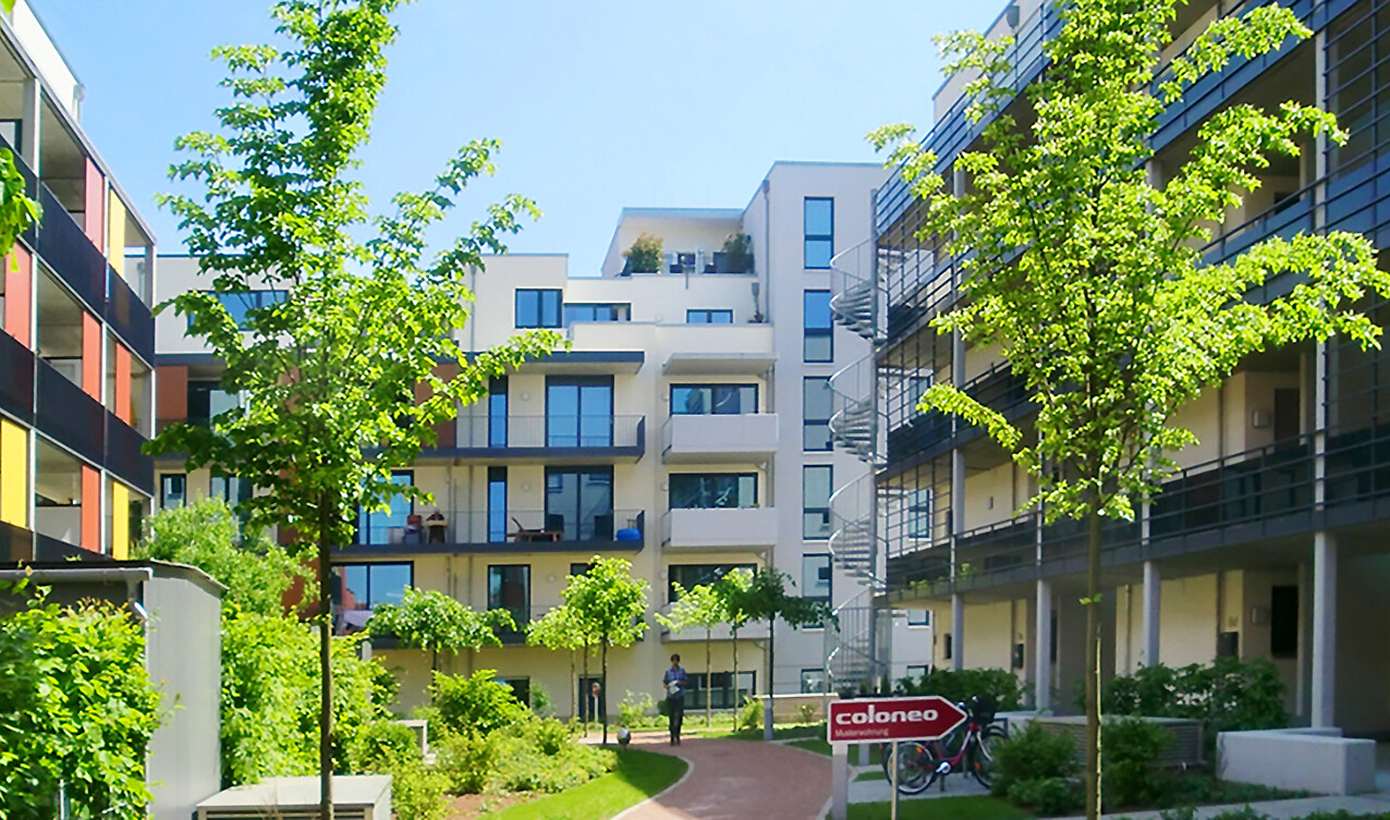Looking from the courtyard at the front view with outside stairs of the BUWOG new construction project coloneo in the Rhein-Main area